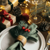 a festive table with a napkin holder decorated with a Christmas theme