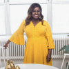 woman with black hair wearing a yellow dress