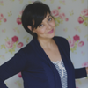 Jennifer Woch against floral wallpaper wall wearing navy jacket over light blouse