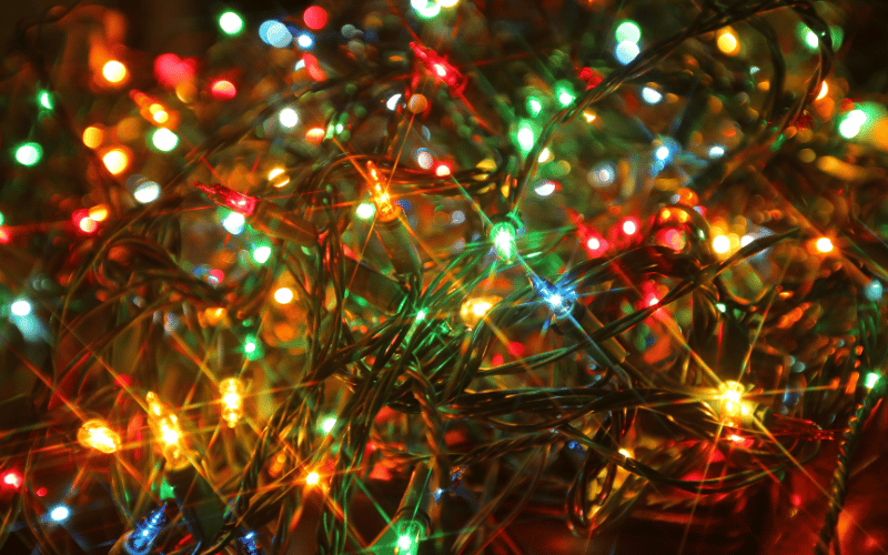 Close up of multicolored Christmas lights on an artificial tree