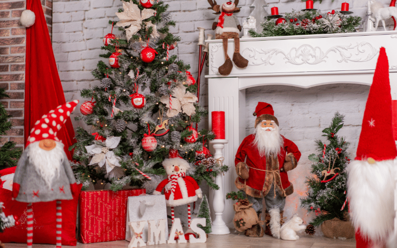 Holiday Decoration with gnomes, snowmen, XMAS signs and traditional Christmas tree with gifts beneath 