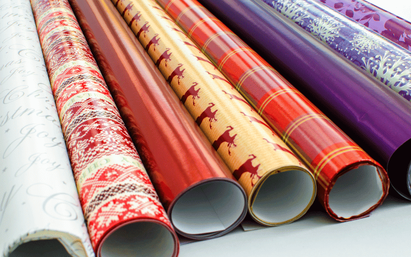 6 Different Colored Rolls of festive gift wrap in a row