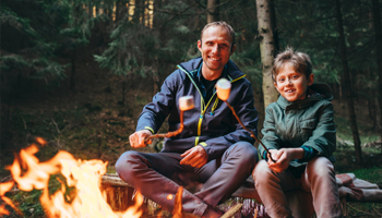 Outdoor Adventure Plan A father and son roasting marshmallows