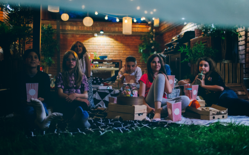 Backyard Family Movie NIght on projector screen and sheet onto house. 