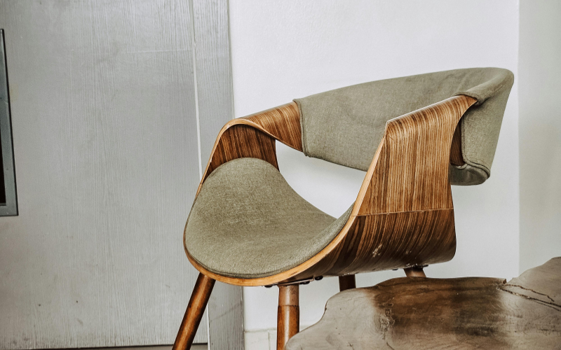 rustic wooden chair in living room next to tree trunk table cottagecore