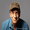 Mike Rowe in blue shirt and brown hat