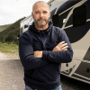 Bryan Baeumler standing in front of a tour bus