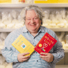 Patric Richardson holding two books