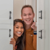 Brian and Mika Kleinschmidt posing by a door frame