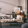 a living room with orange accent furniture pieces