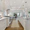 a large white kitchen and wood flooring