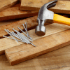 Hammer and Nails over wooden planks