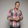 Chris Lambton wearing red, black and white plaid shirt smiling at camera headshot thumbnail