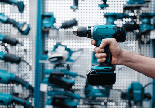 Hand holding blue power drill