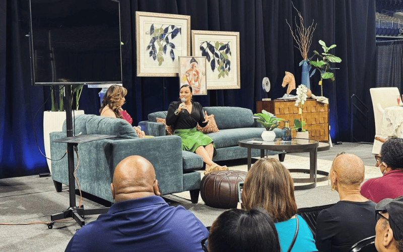 Egypt Sherrod on stage at the Home Show talking to a full audience