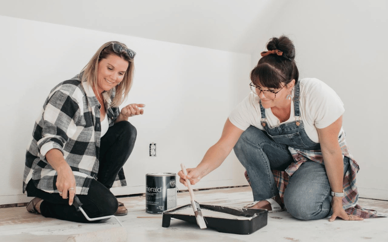 Leslie Davis and Lyndsay Lamb Painting the floor during a project