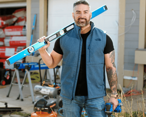 Rico León holding construction supplies and a blue power drill