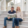 Dave and Jenny Marrs sitting on white steps smiling at camera