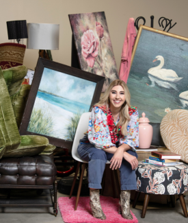 Virginia Chamlee Seated in room full of vintage home decor