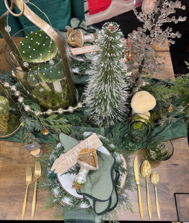 Beautiful green and woodsy tablescape on a dining room table for Christmas 