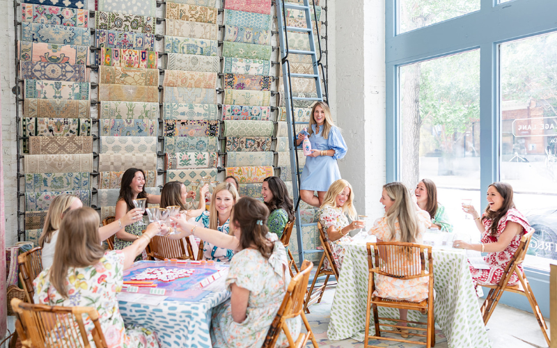 Group of caucasian 20-30-something women in nice sun dresses attending a Mah Jong Party Cheersing their glasses