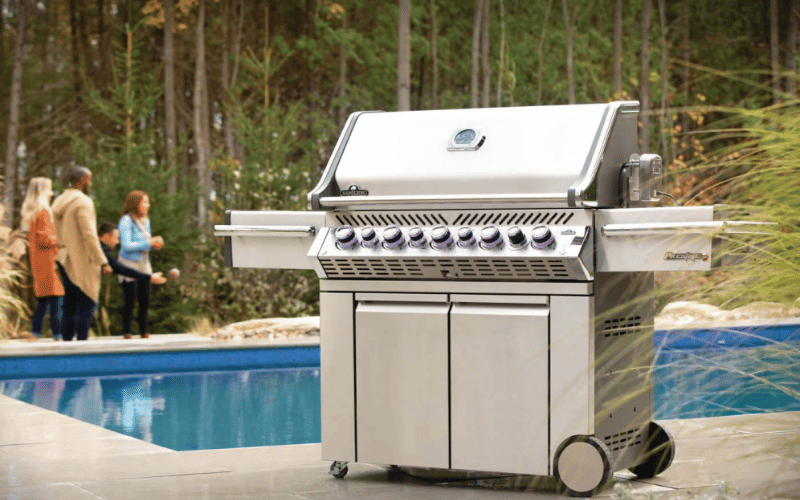 barbecue pool side in woodsy backyard