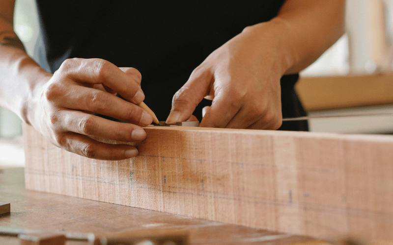 Hands working on Wooden Beam at Home