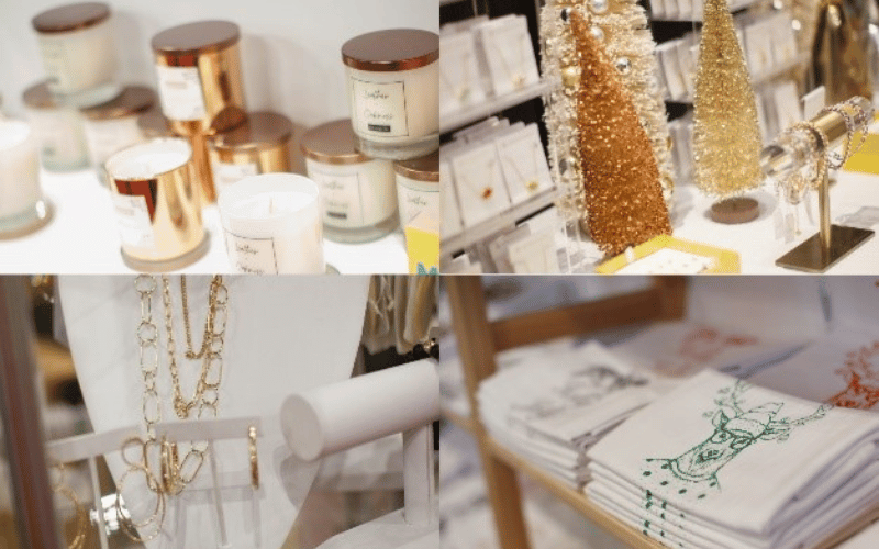 a stand with jewelry, a collection of candles, and two gold Christmas trees  