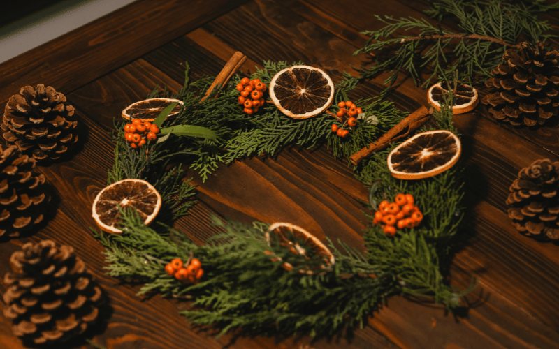 DIY Christmas Wreath with dried fruit, cinnamon sticks and pinecones