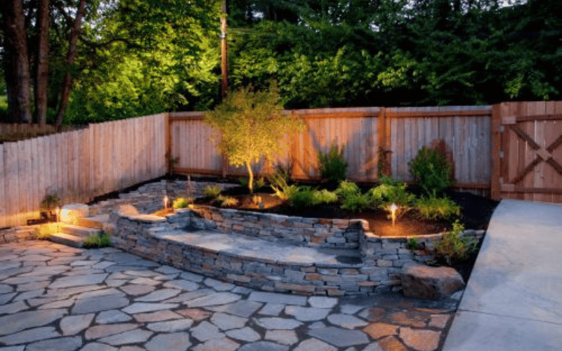 large backyard patio with stones and trees