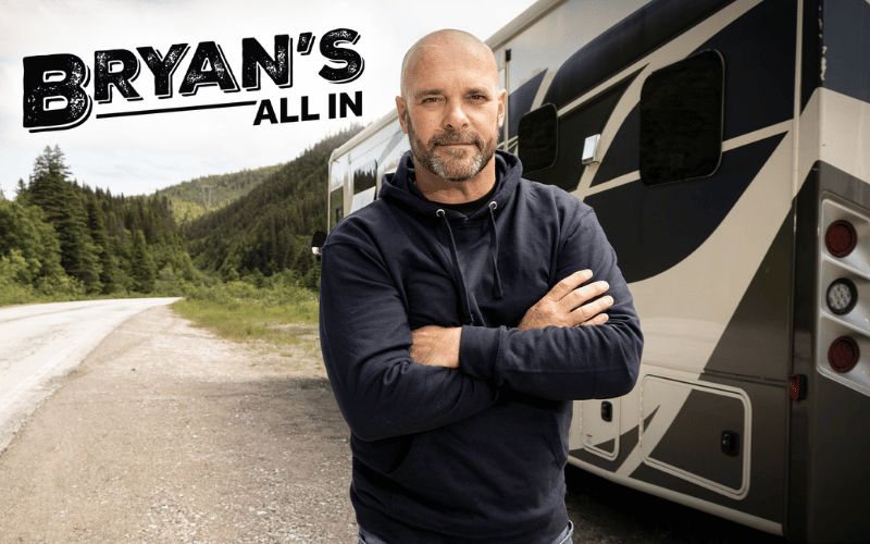 Bryan Baeumler standing in front of a tour bus 