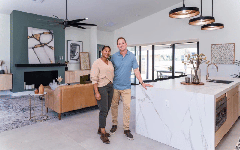 Brian and Mika Kleinshmidt standing in a large open concept kitchen