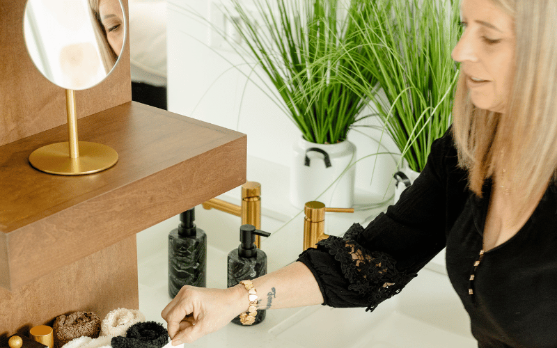 woman organizing toiletries into a desk drawer 