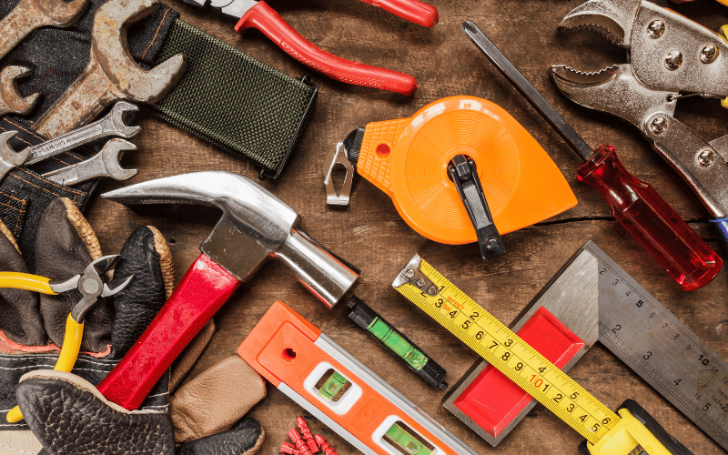 a hammer, ruler, measurement tape, and screwdriver. 