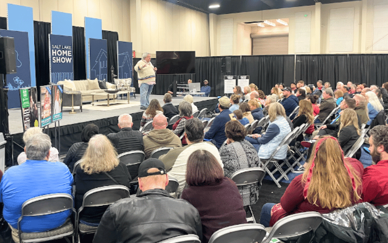 Patric Richardson speaking on a stage to a crowd