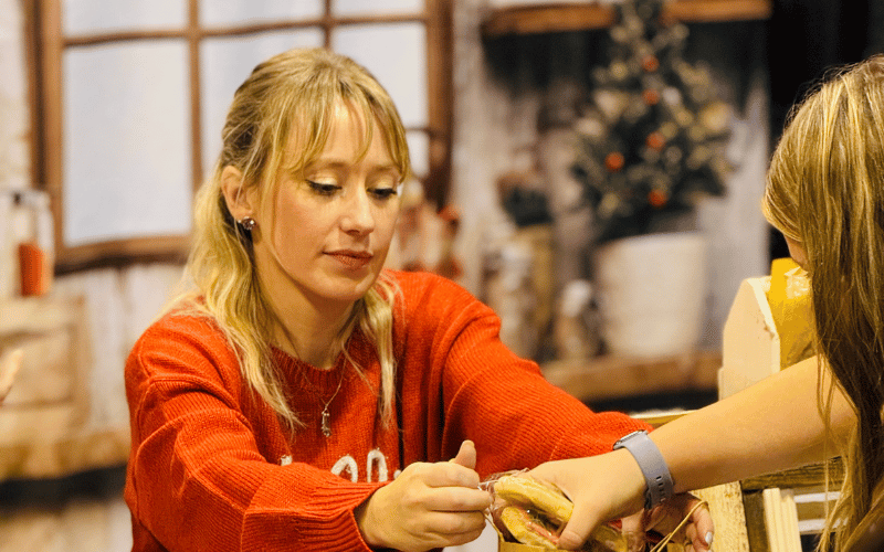 woman handing out a gift bag to a customer
