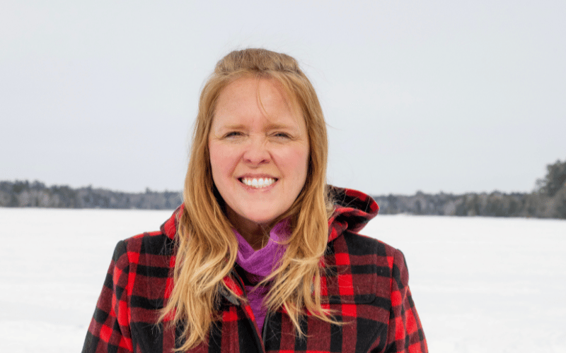Ashley from Maine Cabin Masters wearing a red coat 