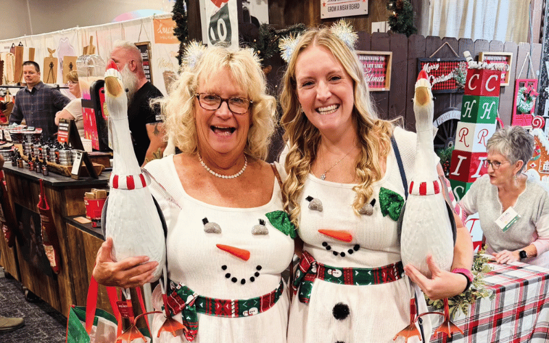 3 two women in snowman themed sweaters at the Cincinnati Holiday Market