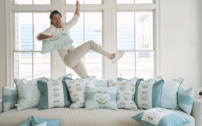 Craig Conover jumping up in a living room 