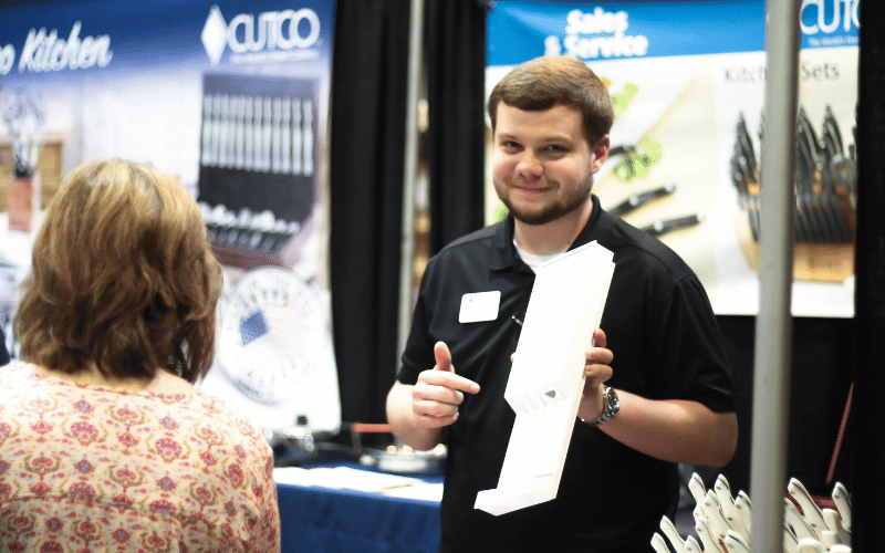 man talking to customers at the Birmingham Home Show