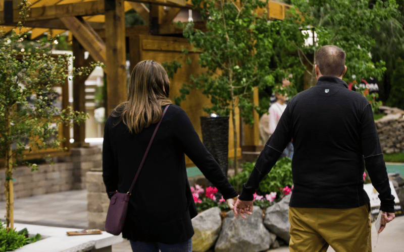 Man and woman holding hands walking through Great Big Home + Garden Show
