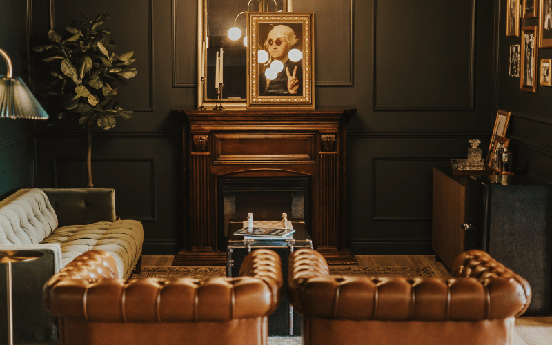 living room with large leather chairs and a fireplace 