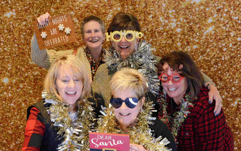 4 women taking photobooth pictures at the Cincinnati Holiday Market