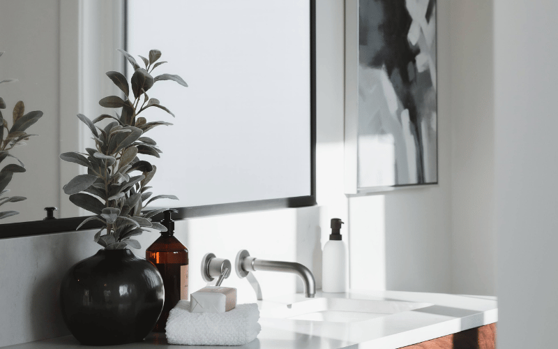 a white bathroom with wood finishes