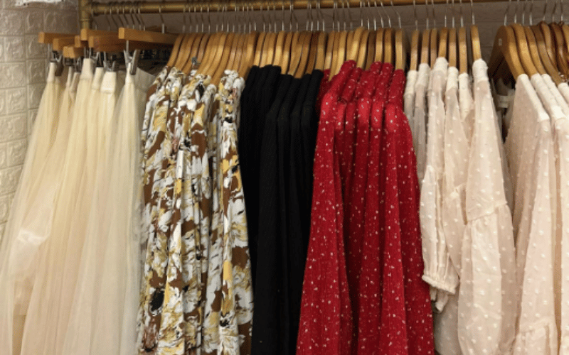 rack of women's dresses in multiple colors