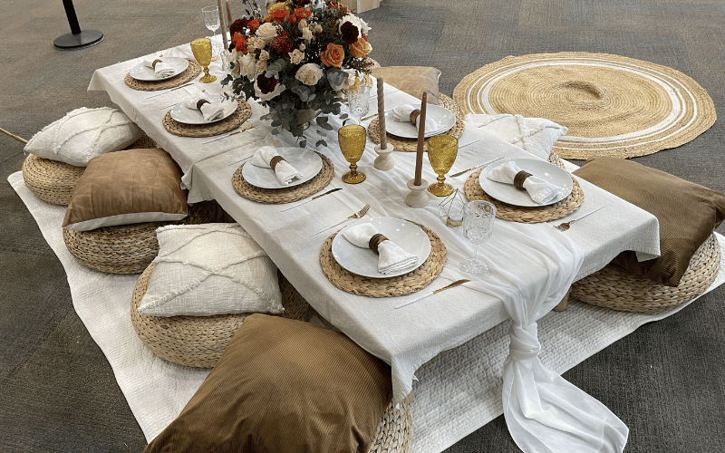 large picnic table with plates and cutlery 