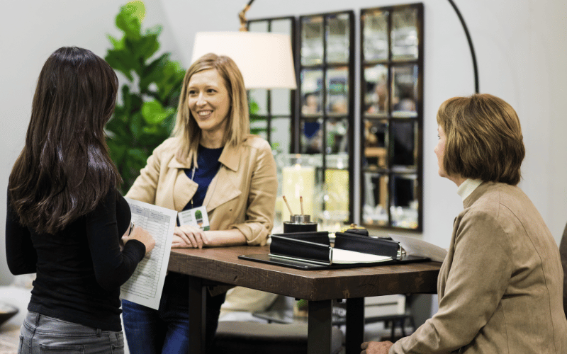 women speaking with paper in their hands 