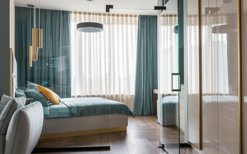 a large bedroom with teal blue accent furniture 