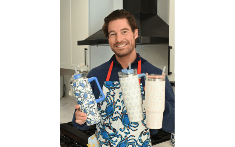 Craig Conover holding three water tumblers