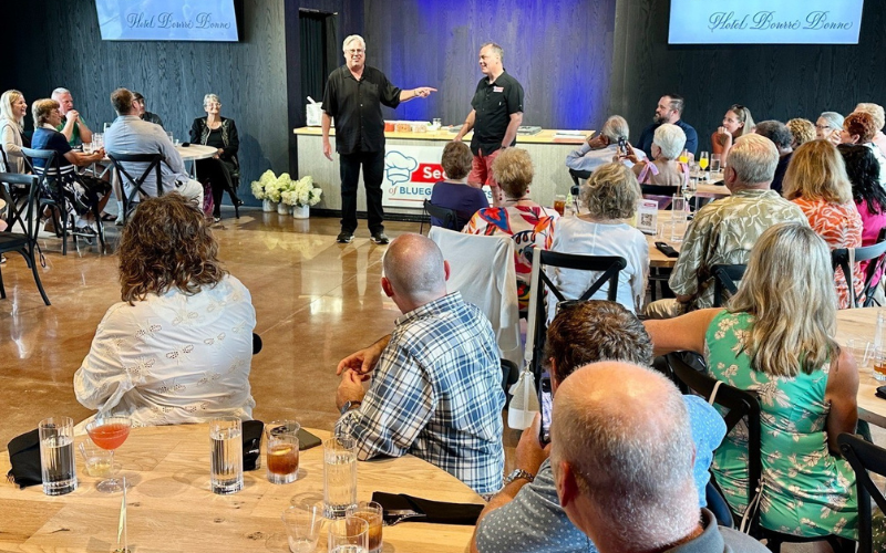 Secrets of Bluegrass Chefs speaking to crowd at tables in auditorium